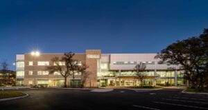 The illuminated exterior of Ridgewood Park Medical Office Building and Ambulatory Surgery Center, showcases modern healthcare construction in San Antonio.